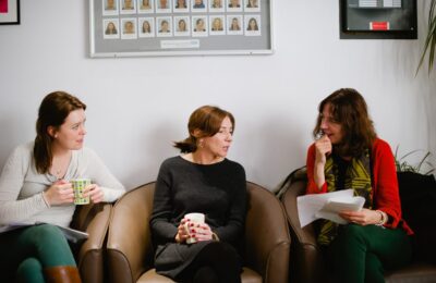 Three women talking in a class of study
