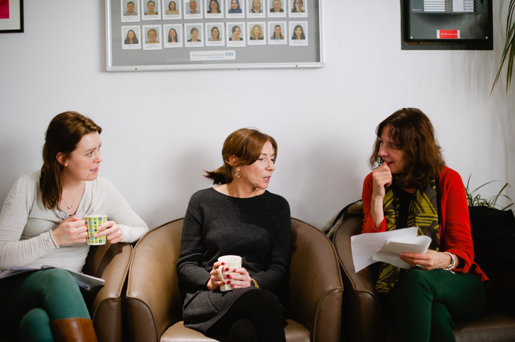 Three women talking in a class of study 