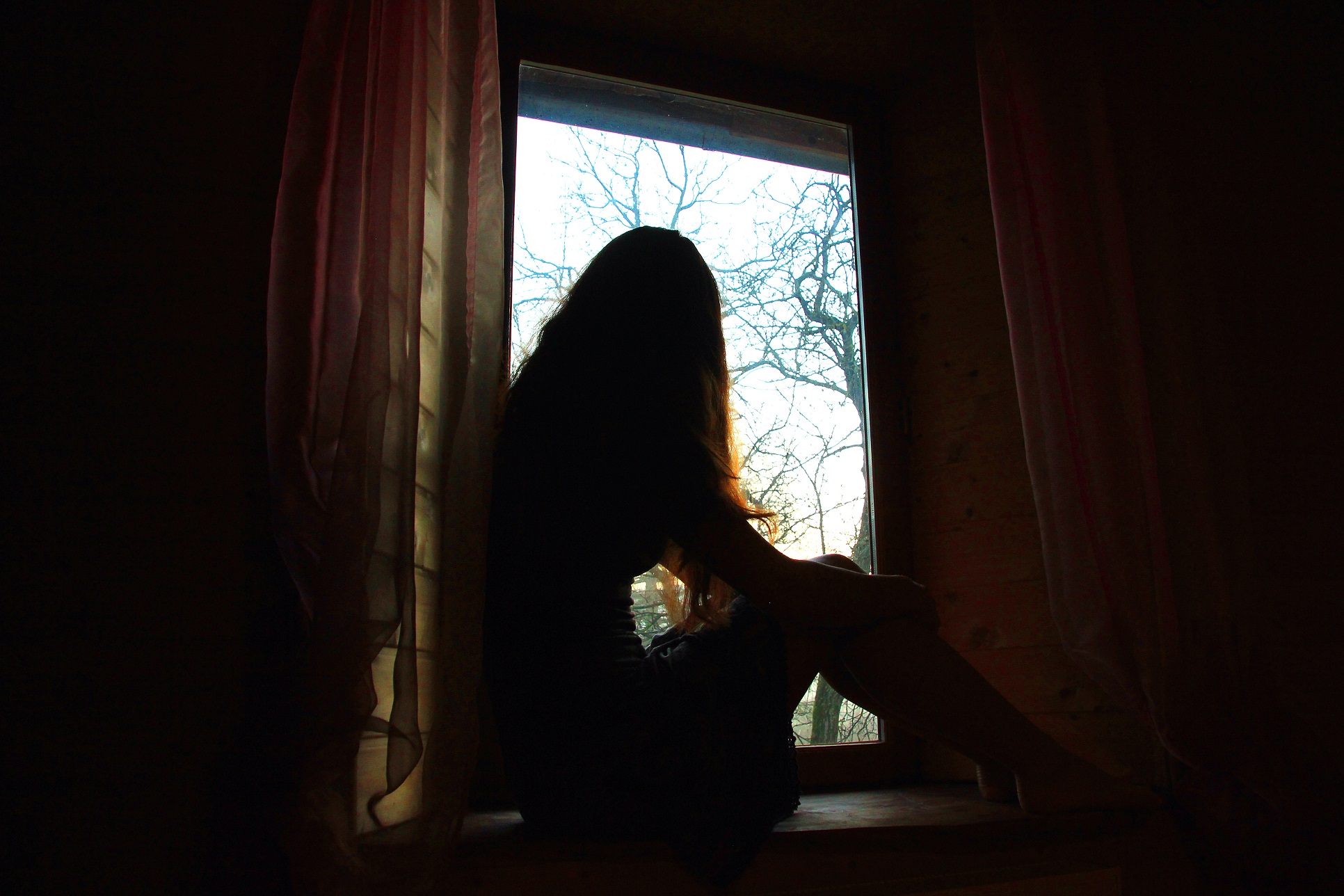 Woman sitting by a window