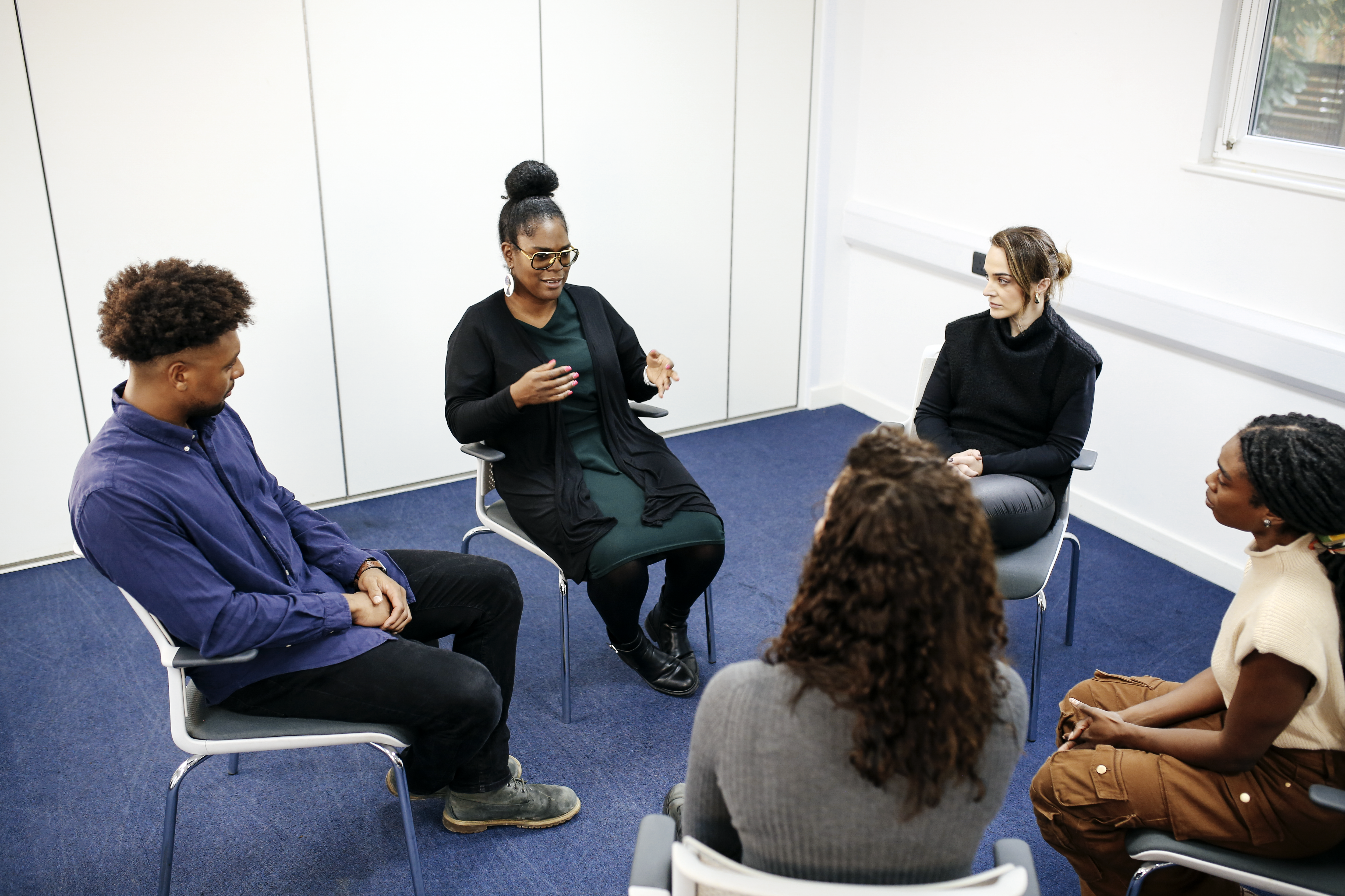 An in-person supervision group in discussion. 
