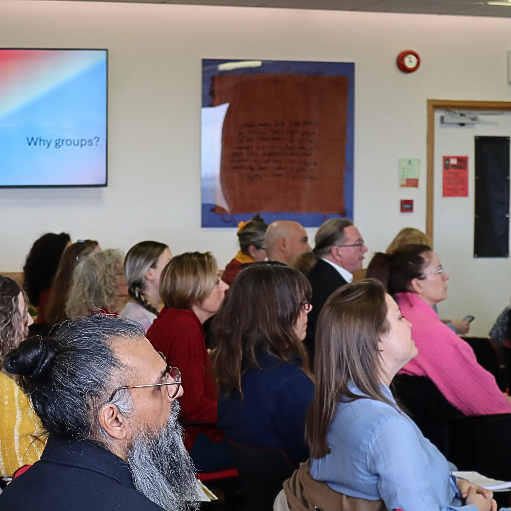 Audience in the lecture theatre listening to a presentation from a conference on complex trauma.