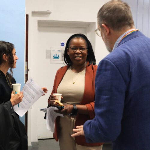 Three people talking during Open Day