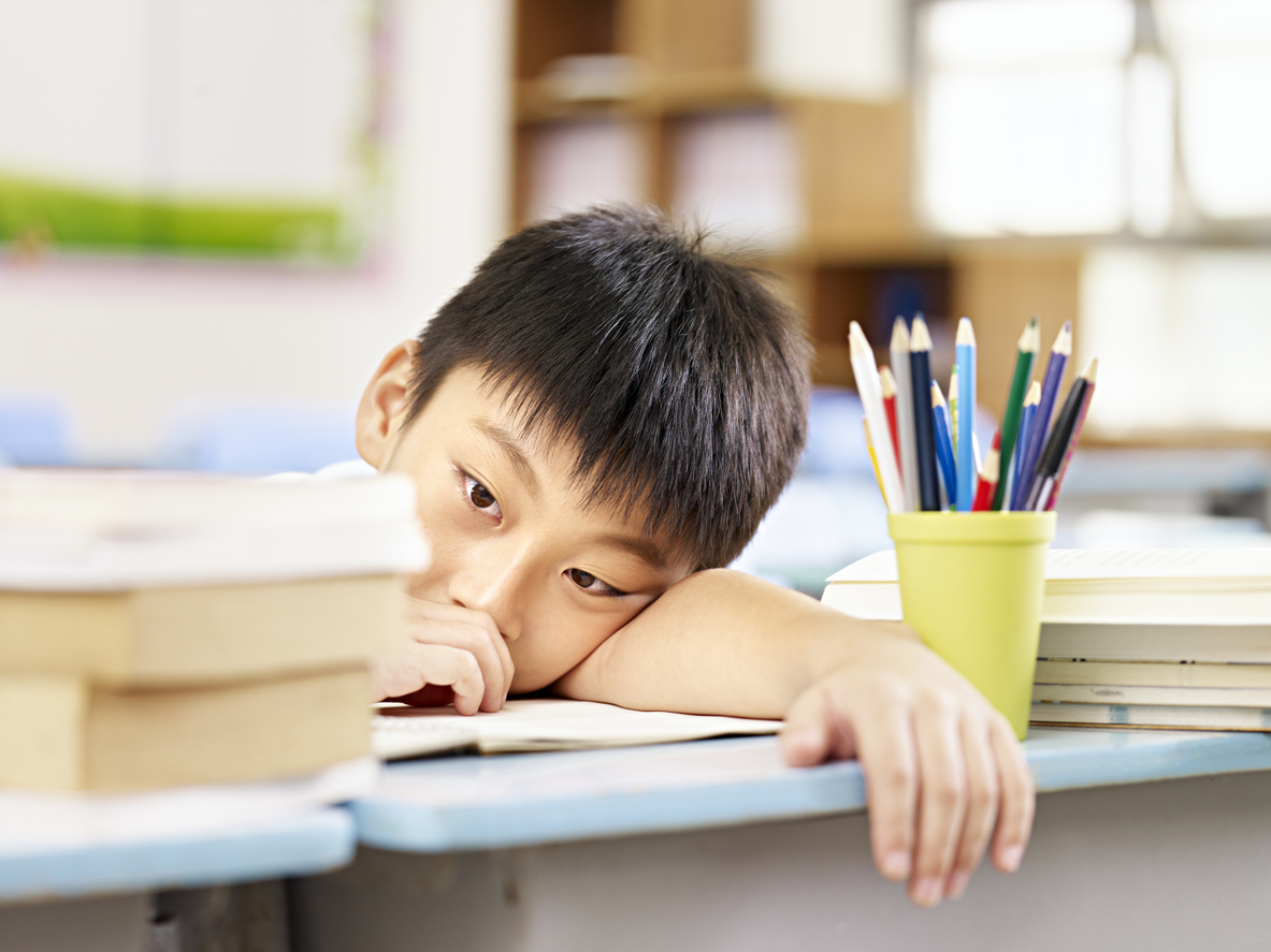 Tired and frustrated child in the classroom.