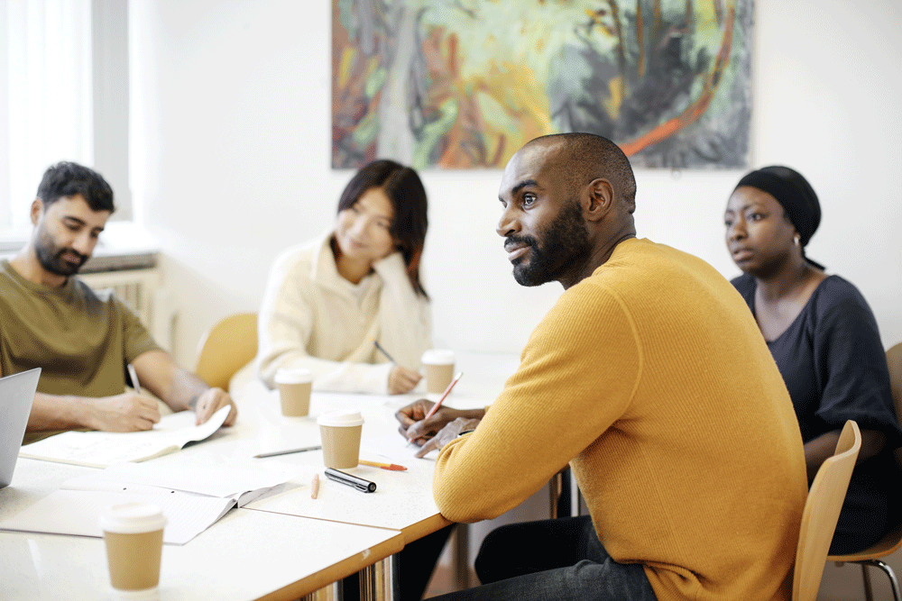 Four students sitting in Tavistock Centre cafe.