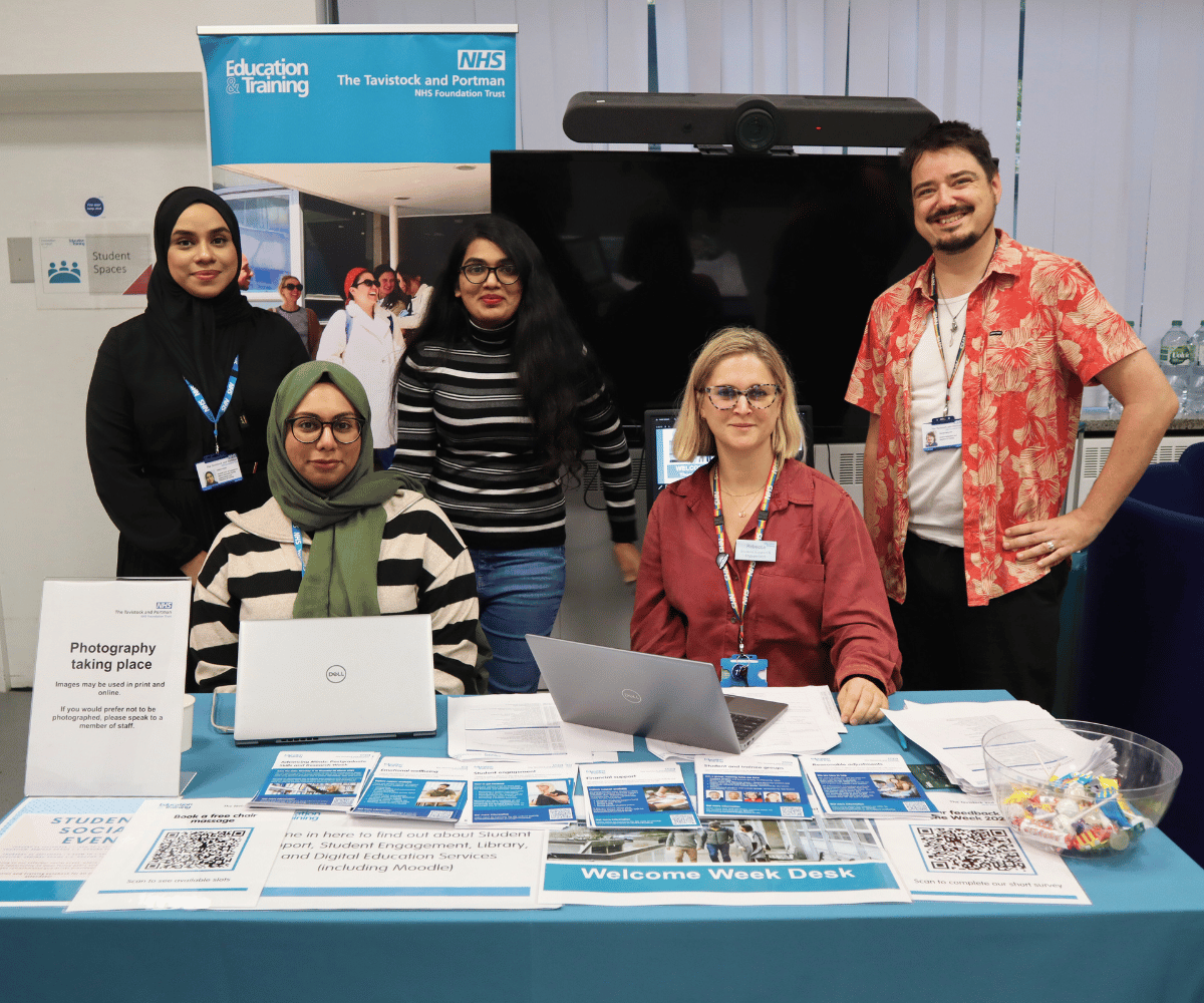 Five members of staff behind the Welcome Desk