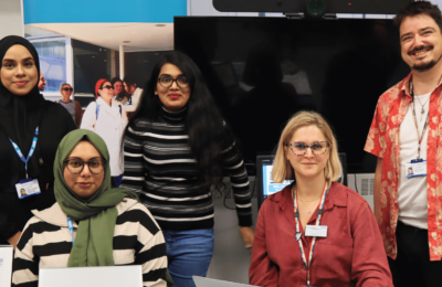 Five members of staff on the Welcome Desk during Welcome Week