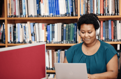 Student Working at Laptop in Library