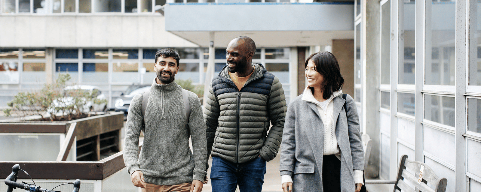 Three students walking outside The Tavistock Centre