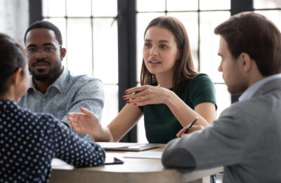A group of young professionals discuss issues together.