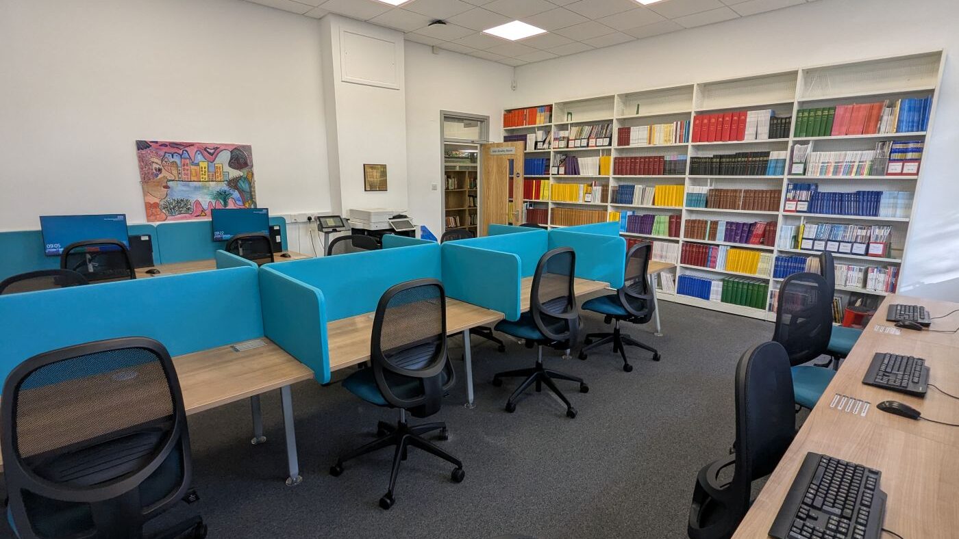 The John Bowlby room with rows of study desks, desks with computers and a shelf of journals