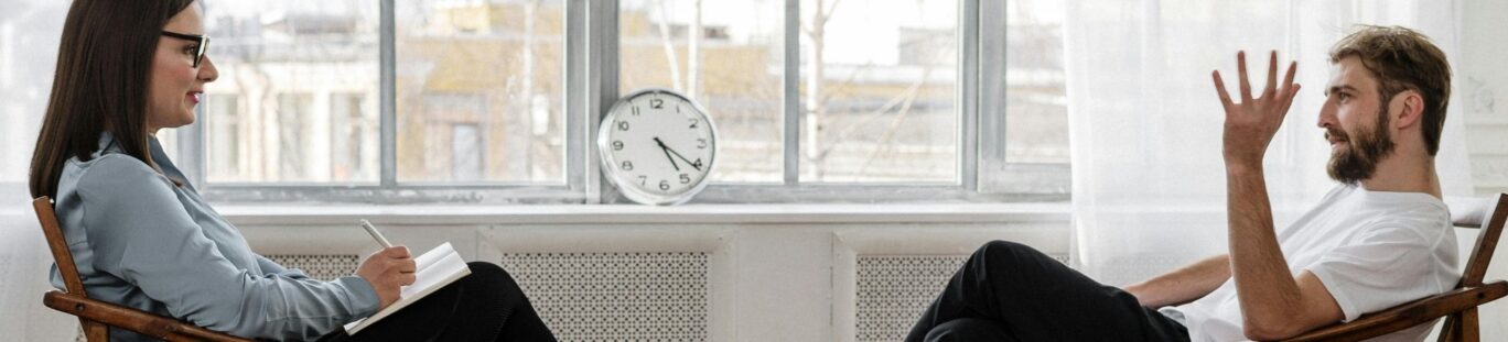 A therapist and patient talking in a therapy room